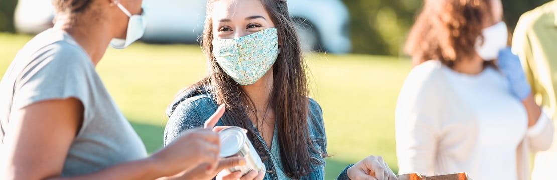 Two friends volunteer at a food drive